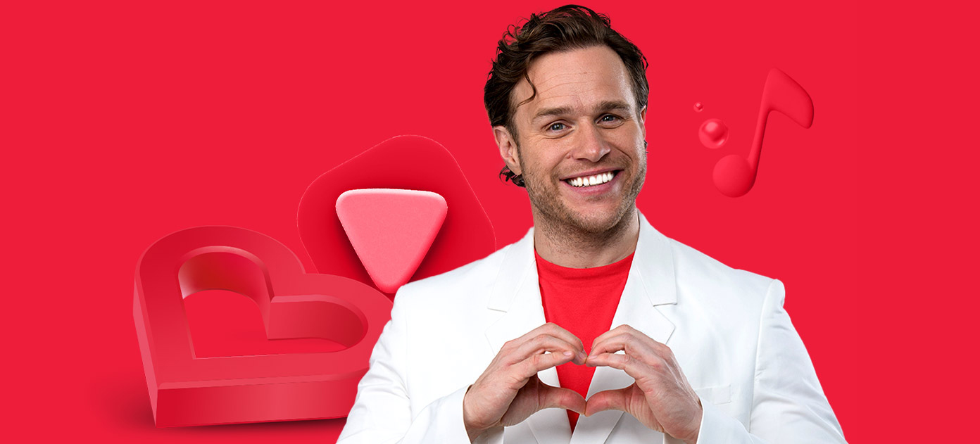 Olly Murs makes a heart with his hands