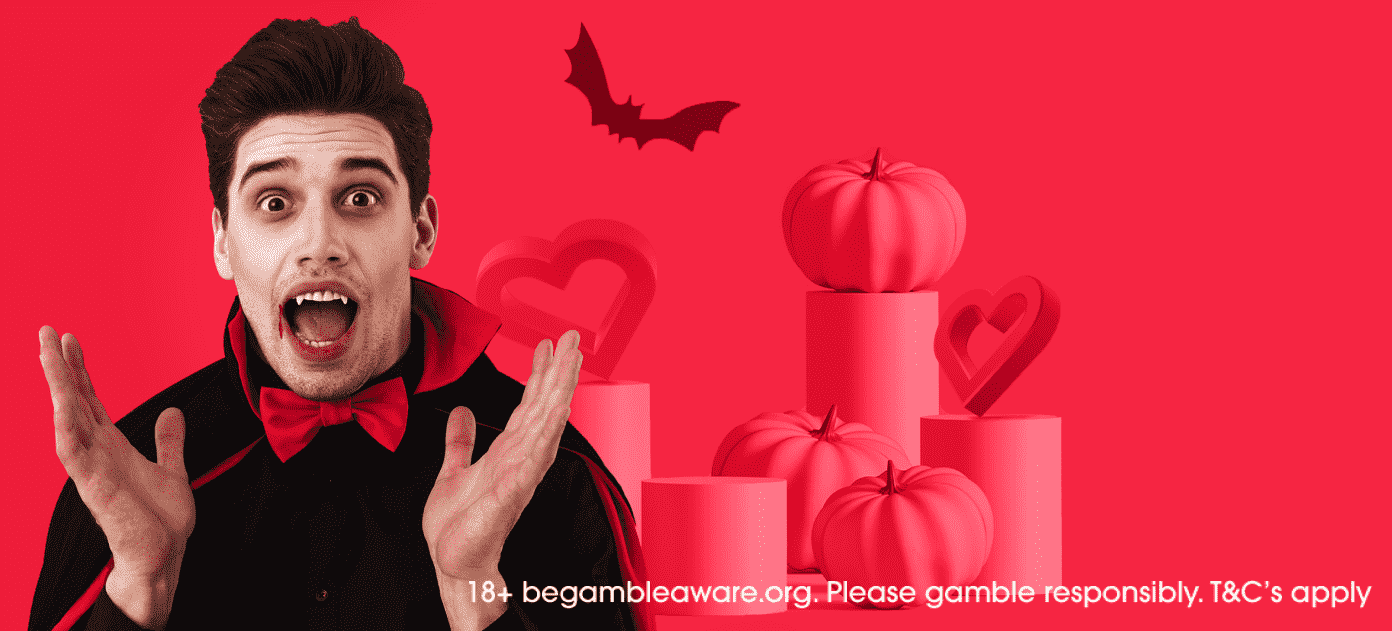 man in vampire costume with pink pumpkins in background