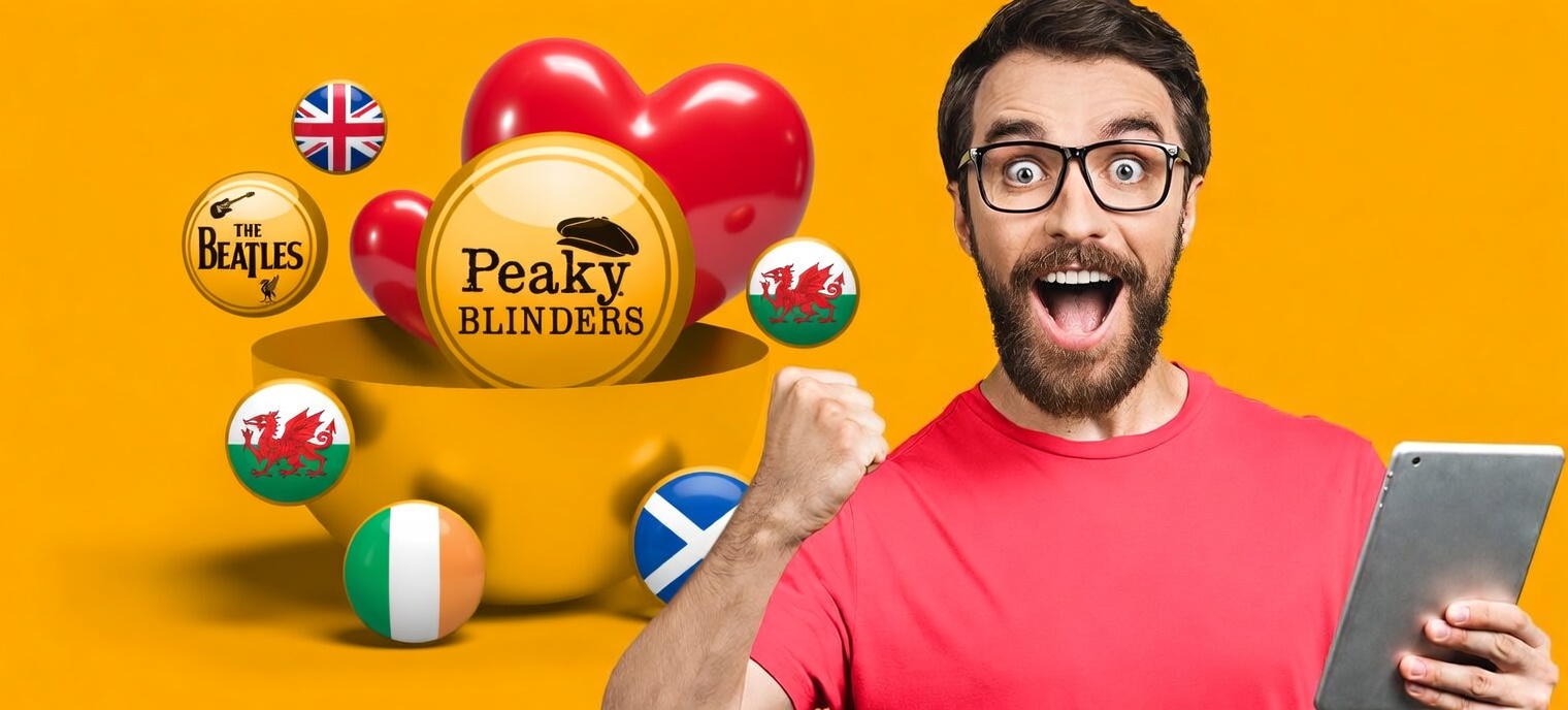 Excited man with glasses celebrating while holding a tablet, surrounded by golden balls featuring Peaky Blinders, The Beatles, Harry Styles, I’m A Celebrity, a big red heart, and the flags of the UK, Wales, Scotland, and Ireland.